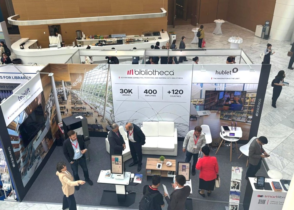 Bibliotheca and SmartLibrary booth at IFLA WLIC 2025 with visitors exploring digital library solutions.