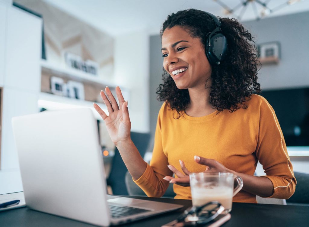 -lady waving on a conference call on laptop