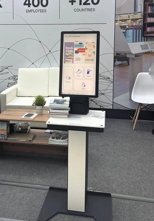 Bibliotheca selfCheck 2500 unit at the IFLA 2025 booth, showing a user-friendly interface for library patrons.