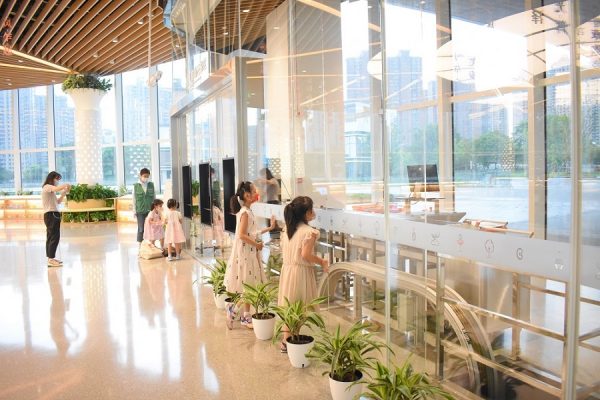 Children observing an automated book return system at the Shanghai Public Library