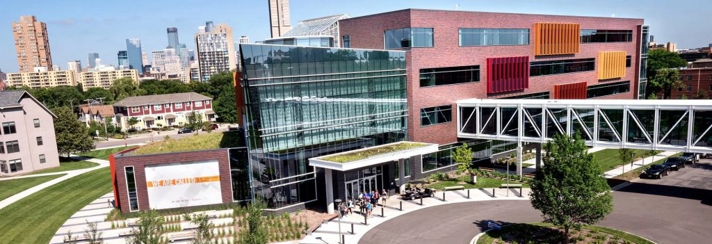 Aerial view of Augsburg University’s International Center in Minneapolis, with modern architecture and the city skyline in the background.