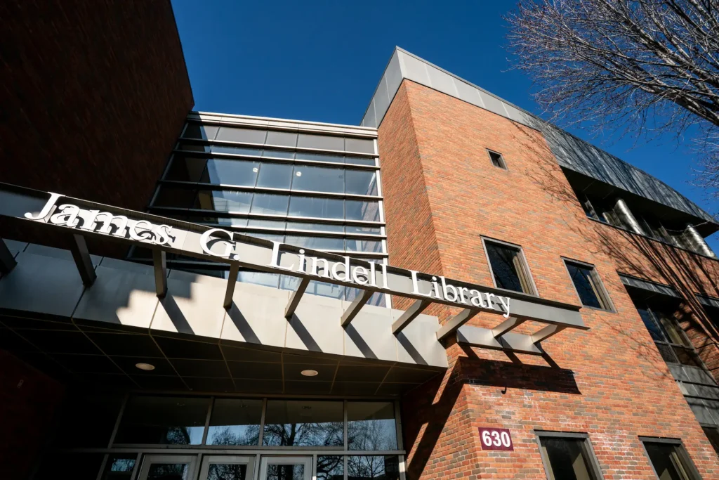 Exterior view of the James G. Lindell Library at Augsburg University, with its red brick architecture and modern glass design.