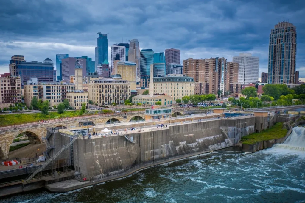 View of St. Anthony Falls and the Stone Arch Bridge with the Minneapolis skyline, located near Augsburg University.